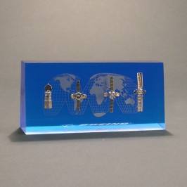 4 miniature space satellite modules embedded within Lucite award. 