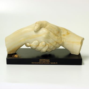 Custom molded stone award in shape of two hands shaking in partnership