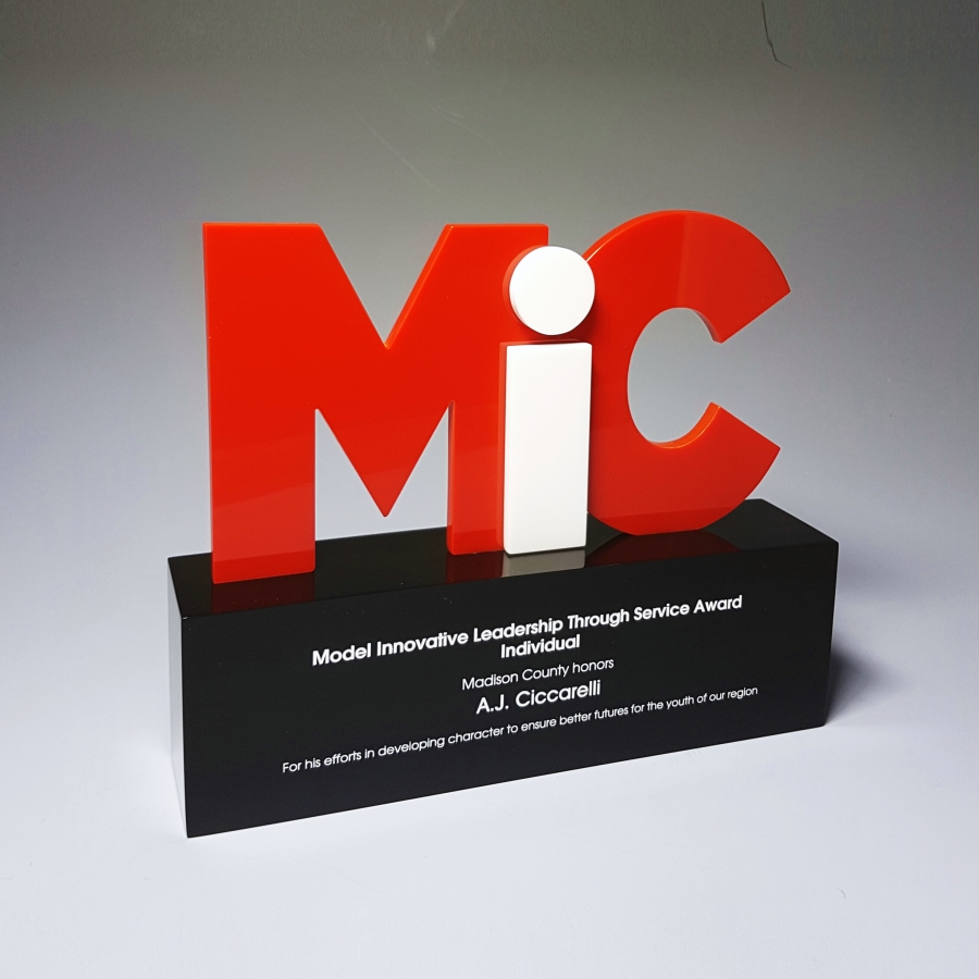 Black base with red and white letters made of Lucite trophy or award